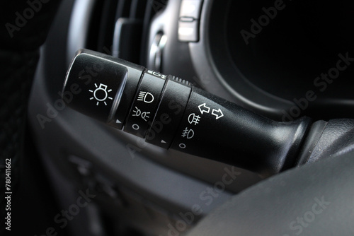 Turn signal lever, adjusting car headlight control switch.