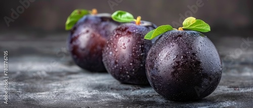 A cluster of plums atop a rain-dotted table, adorned with overhead leaves