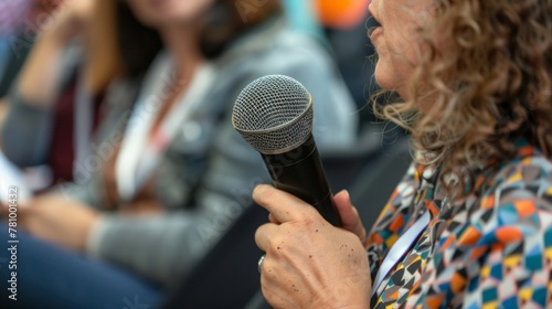 A closeup of an interpreters hands holding a microphone as she facilitates communication and creates a bridge between two cultures promoting mutual respect and appreciation. .