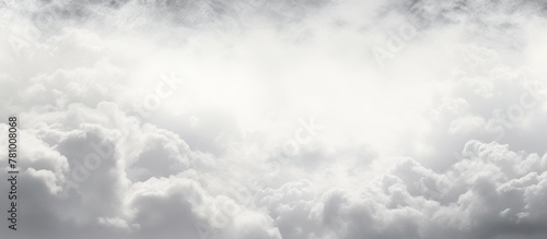 High in the sky, a jet plane navigates through billowing white clouds, on a journey to its destination