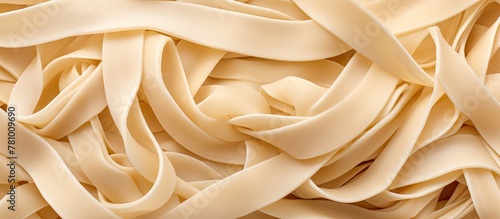 Close-up view of a heap of pasta noodles, showcasing their texture and shapes, set against a clean white background.