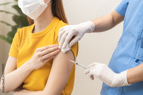 Health care, corona virus, hand of woman nurse, doctor giving syringe vaccine, injection dose on arm sick patient at clinic. Vaccination, immunization disease prevention against flu pandemic influenza