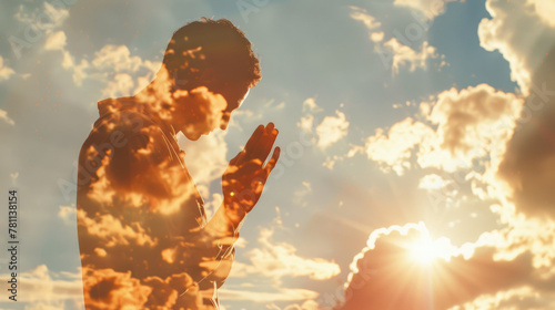 Young man praying against the sky with clouds and sunlight, illustration in double exposure style, close-up.