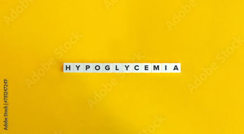 Hypoglycemia Word. Low Blood Sugar Concept. Text on Block Letter Tiles on Yellow Background. Minimalist Aesthetics.