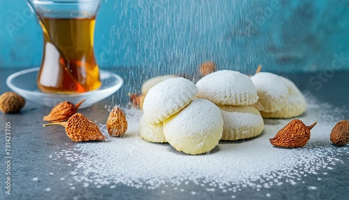 Delicate Eid Sweets with Tea- Celebratory Maamoul Cookies and Powdered Sugar on Kahk 