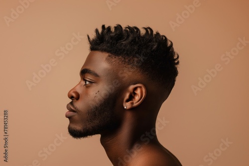 Detailed side portrait of a young man showcasing a trendy fade hairstyle