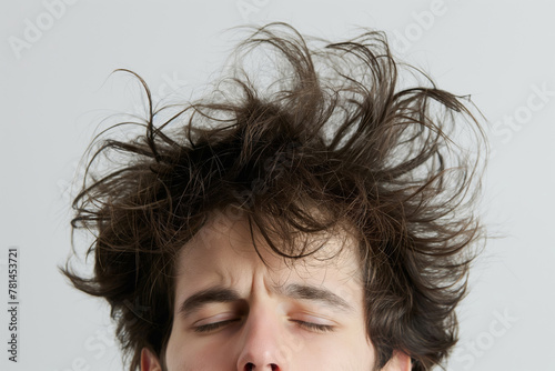 Close-up photo of a young man's messy bedhead, expressing a carefree attitude