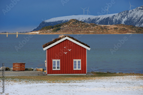 Winter landscape with red boathouse near Alesund, Norway.