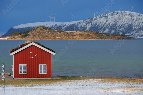 Winter landscape with red boathouse near Alesund, Norway.