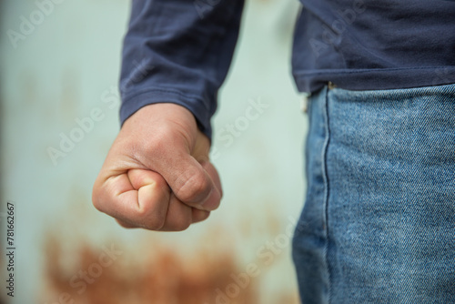 Man clenches his fist tightly in anger, hand close up, emotion concept, stock photo