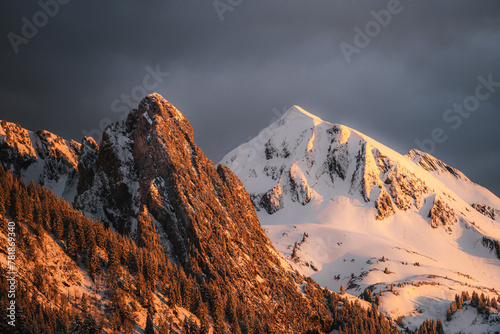 Sunset over mountains covered in snow
