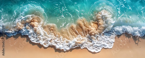 Overhead view of crystal-clear waves lapping against a tropical beach, perfect for tranquil and serene concepts.