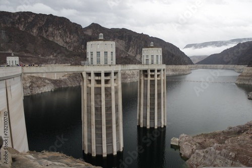 The majestic hydroelectric dam stands tall, harnessing the force of rushing waters to generate clean and sustainable energy for the surrounding region.
