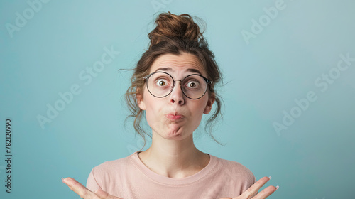 Portrait of a confused puzzled minded woman on pastel blue background
