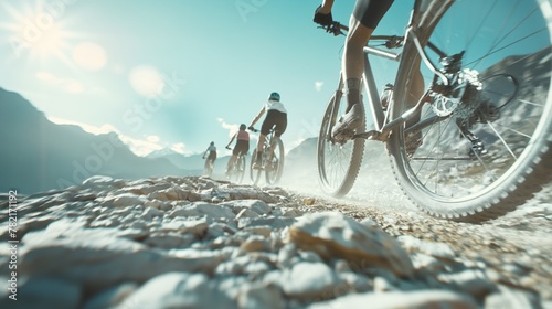 Close-up of a mountain biker riding on a dirt road in the mountains