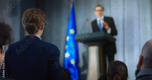Female representative of media asks question to European politician performing at press conference. Confident EU consul makes an announcement, delivers campaign speech, gives interview. Election day.