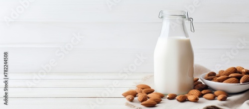 Almond milk bottle and almonds bowl