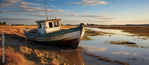 Abandoned boat at river marshlands