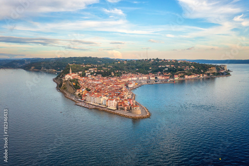 Aerial view of Piran old town, Slovenia, beautiful landmark. Scenic cityscape with medieval architecture and red tiled roofs, famous tourist resort on Adriatic seacoast, outdoor travel background