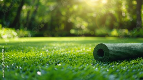 Green yoga mat lies on a vibrant lawn, rready for a healing session amidst nature’s embrace, copy space