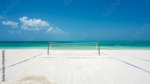 Empty beach volleyball court, with pristine white sand, clearly marked boundary lines, and a taut net under the clear blue sky. Concept of summer sports, beach activities, and tropical vacation.