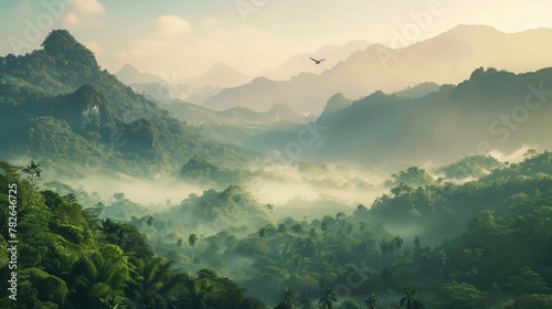 A panoramic view of a mountain forest bathed in the soft light of dawn after a night of rain. Mist hangs low over the valley, slowly revealing the majestic peaks cloaked in lush greenery. A lone bird 