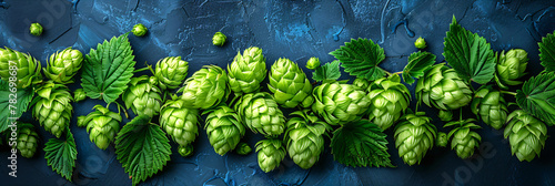 Green fresh hop cones for making beer and bread on black stone table. Brewery and Oktoberfest concept. Herbal natural medicine. Background for design banner, poster, card. Flat lay, top view