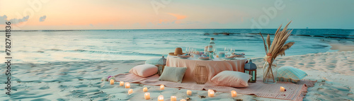 A beach scene with a table set up with candles and a vase of flowers. Scene is romantic and peaceful
