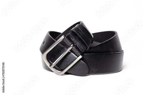 Twisted black leather belt with matted metal buckle isolated on white background. Fastened fashionable unisex, man or woman accessory for trousers, jeans, dress. Male luxury strap. Haberdashery goods