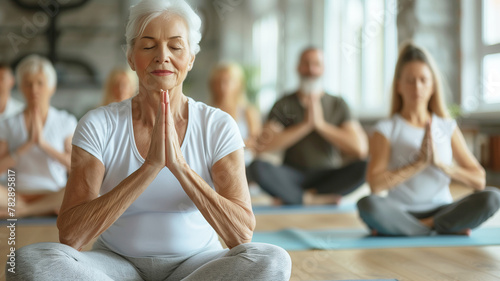 Older women practice yoga, meditate in yoga classes and lead an active and healthy lifestyle. Retirement hobbies and leisure activities for the elderly. Bokeh in the background.