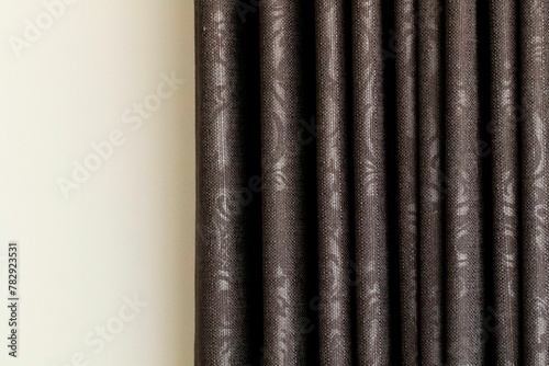 Closeup of the texture of black elegant curtains on a white wall