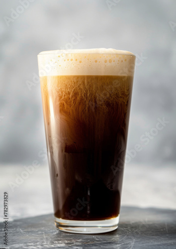 Product photo of nitro cold brew coffee, on slate surface, isolated on white background. studio lighting.