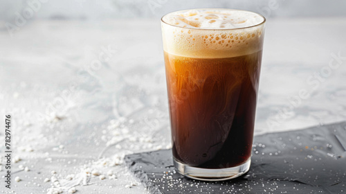 Product photo of nitro cold brew coffee, on slate surface, isolated on white background. studio lighting.