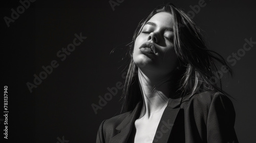 portrait noir et blanc studio d'un jeune femme en tailleur noir, espace pour texte