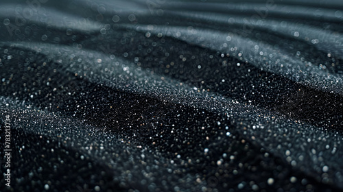 Shiny black crumpled fabric texture ,Black sand waves as background ,Raw sand texture on clear backdrop, Black and white grainy dot grime design