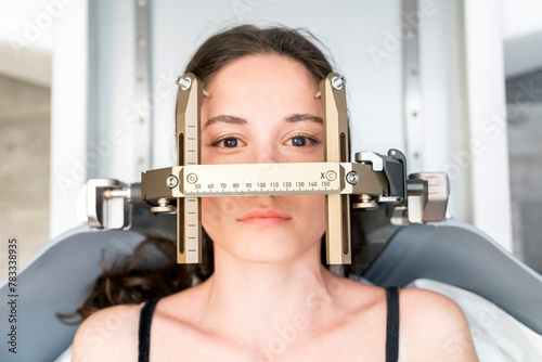 The patient lies in front of the device for the treatment of cancer with a gamma knife. She has a metal clip cap on his head. Gamma Knife stereotactic radiosurgery.