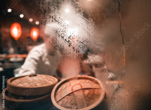 condensation on the window in a Chinese kitchen with dim sum wooden steamer basket