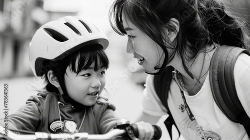 A mom teaching her child to ride a bike, encouragement and pride shining in her eyes.