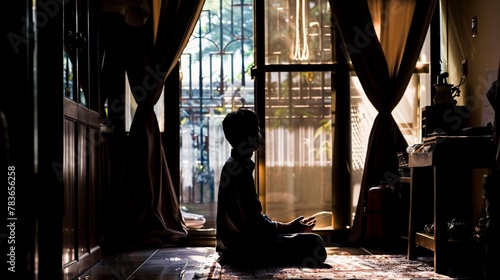 A quiet moment of an individual performing Tahajjud, the night prayer, in the solitude of their room, highlighting personal reflection and spirituality.
