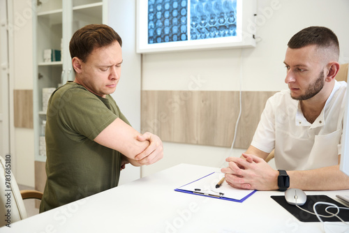 Patient complaining of elbow joint pain to traumatologist