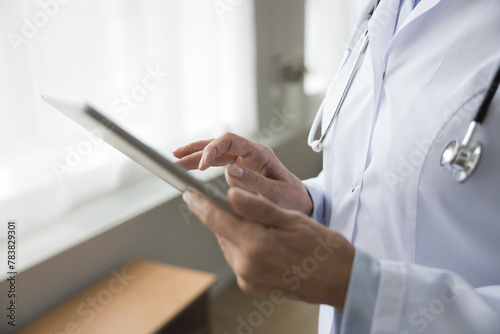 Close up female therapist working on digital tablet, conduct virtual consultation, review patient disease history, discuss symptom, provide medical advice, recommendations using telemedicine platforms