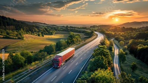 Two trucks overtake each other on a serene rural road under a stunning sunset sky
