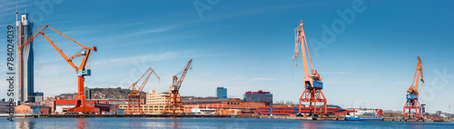 Gothenburg port loading cranes panorama against a backdrop of skyscrapers and blue skies, concept of maritime and industry. Gothenburg, Sweden