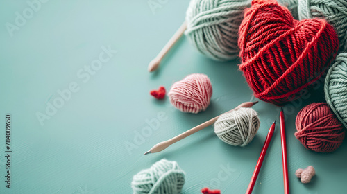 Various wool yarn knitting needles and stuffed heart