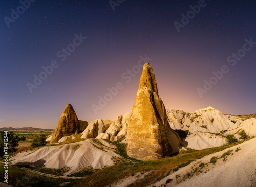 Rocks and the sky with stars. Cappadocia, Turkey. View of the rocks at night. Landscape in the summertime. UNESCO heritage. Vacation and tourism.