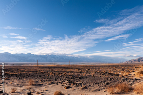 The towering mountains of the Sierra Nevada form a backdrop of the road to Lone Pine, California.