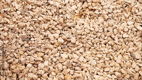 background, yellowish gravel with reflections of sunlight