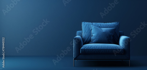 Sleek blue armchair with soft texture against a dark blue backdrop.