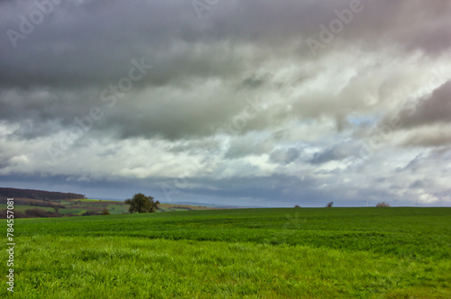 Stromy sky over the green fields: landscape