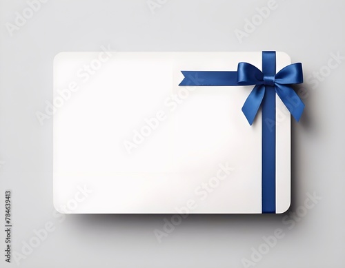 Blank white gift card with blue ribbon bow isolated on background with shadow minimal conceptual